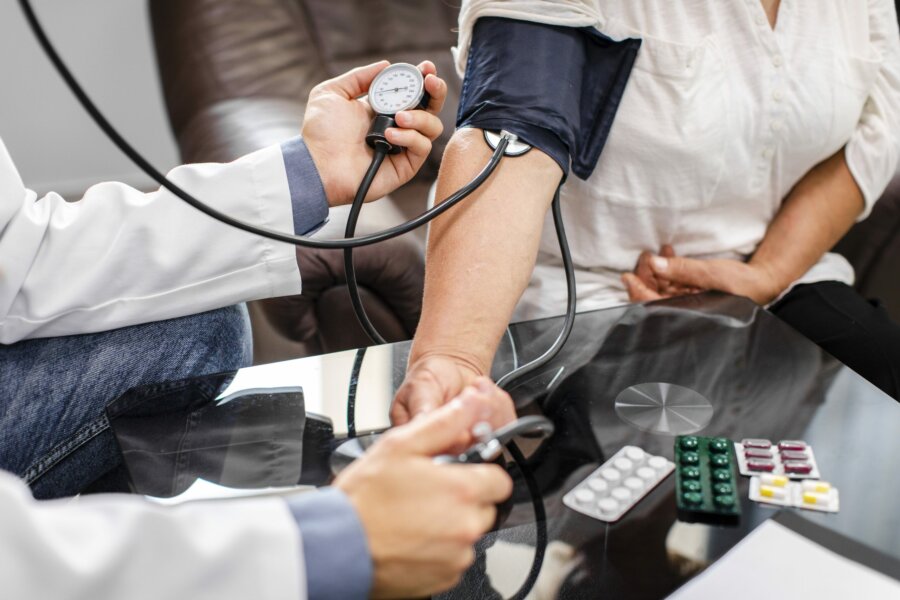 male-doctor-hands-measuring-tension-patient